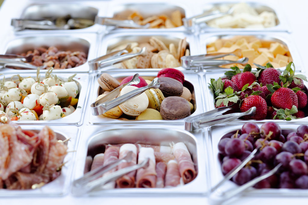 Charcuterie spread with meats, cheeses, macarons, and fresh fruit
